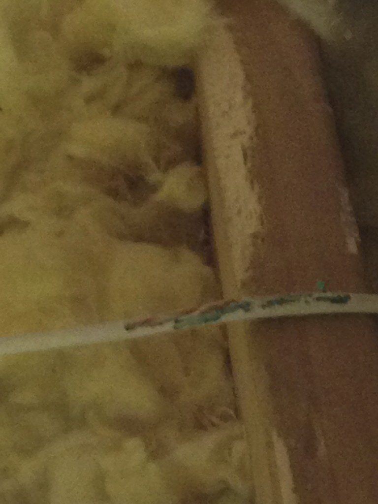 Damaged cable near insulation material