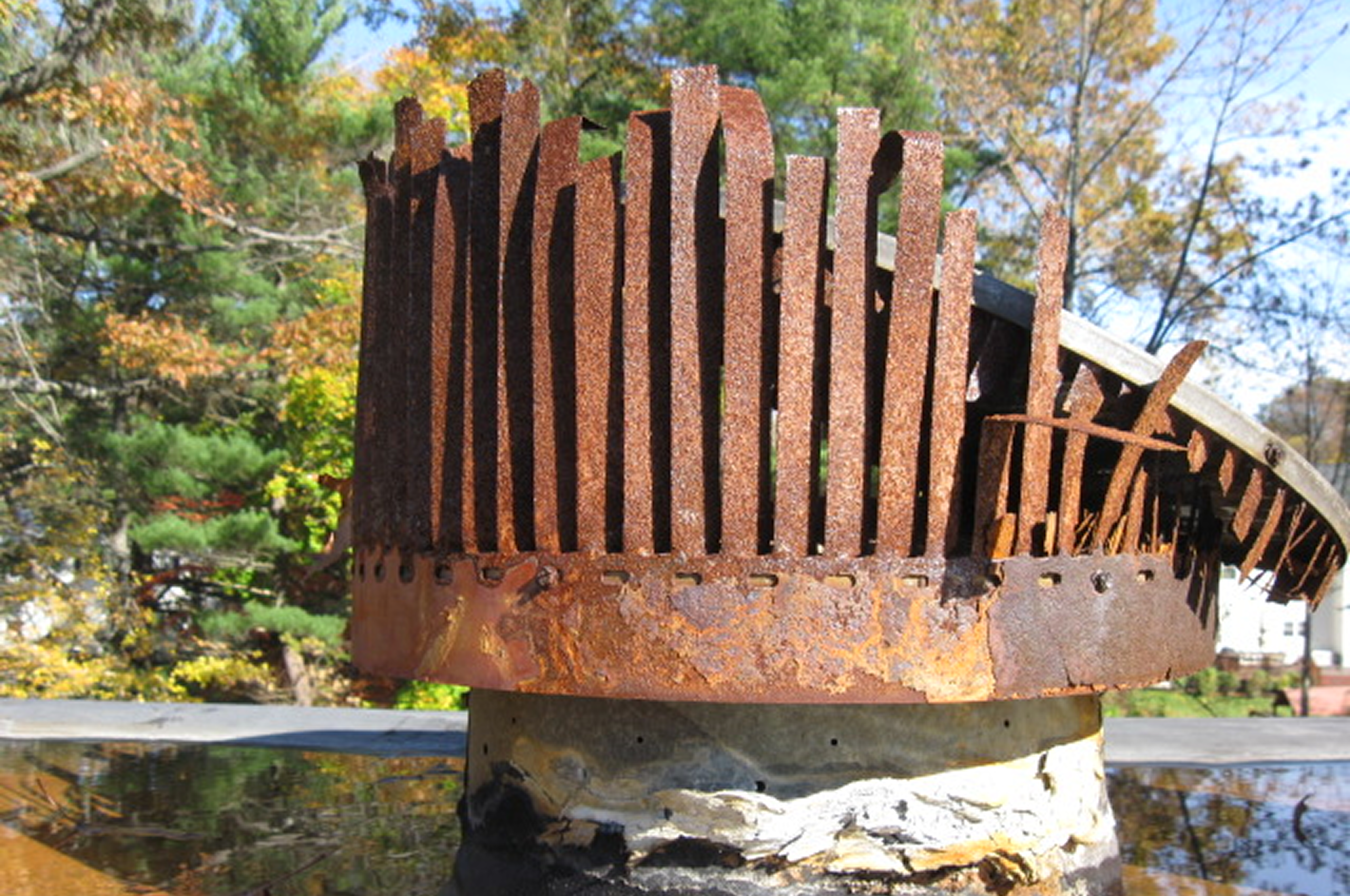Weathered metal chimney cap in sunlight