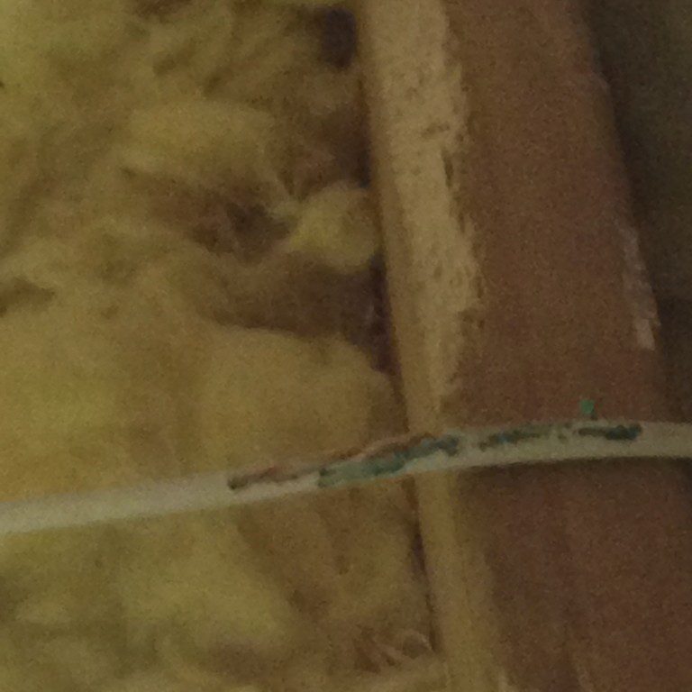 Damaged cable near insulation material
